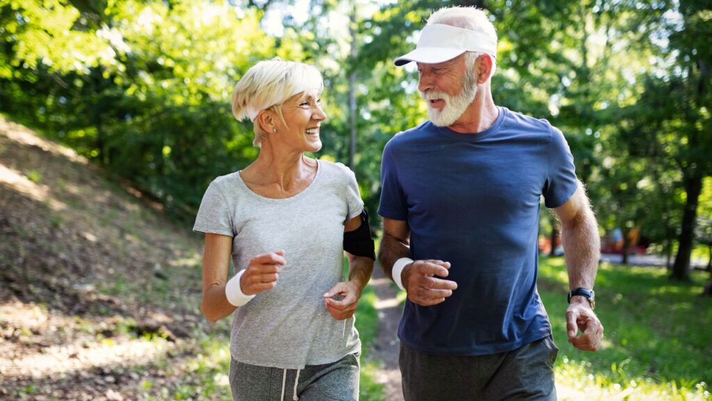 Mature,Couple,Jogging,And,Running,Outdoors,In,City