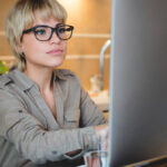 Young-Woman-Glasses-Computer-Monitor-Working-Research